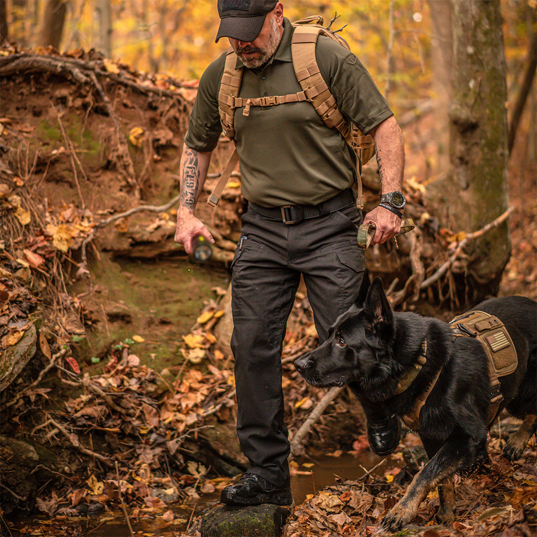 Image of a man and a dog out in the forest. Shop Search & Rescue.