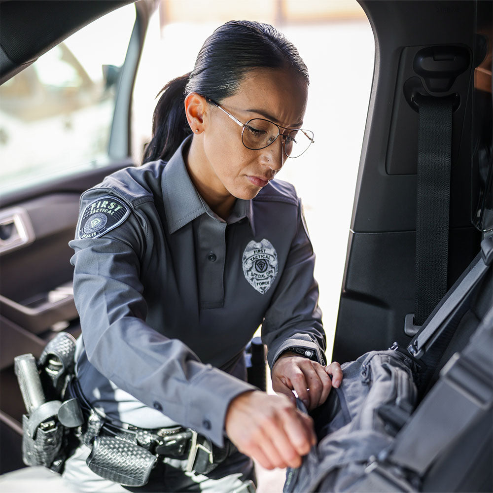 Image of a woman officer wearing V2 pro performance shirt going through bag