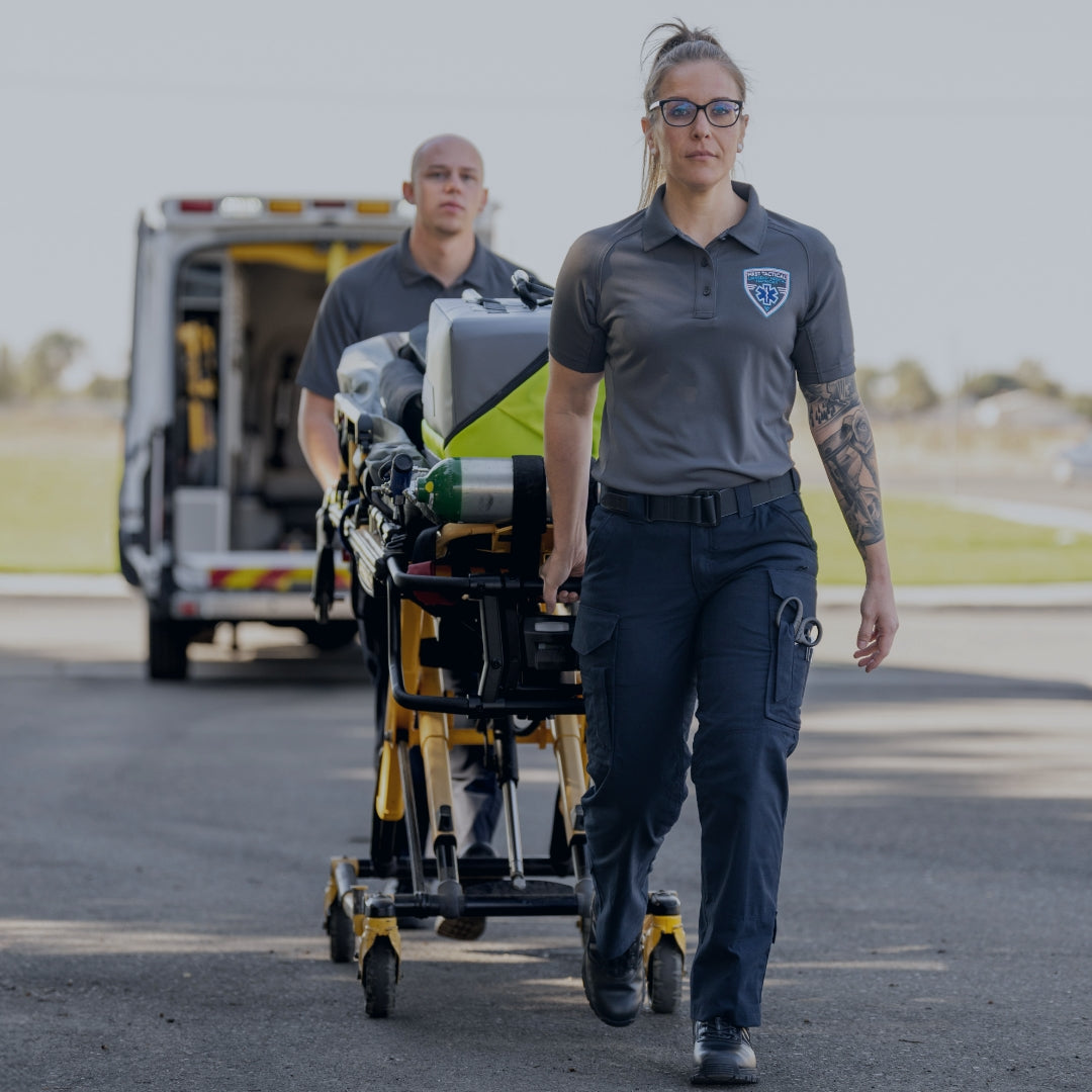 Two EMS professionals pulling a cart with medical supplies. Shop EMS & Medical.